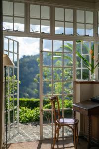 a room with a window with a desk and a chair at Nine Skies By Teardrop Hotels in Ella