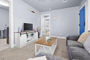 a living room with a couch and a tv at YeeHaw BnB in Amarillo