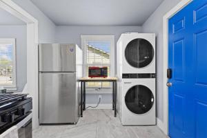 a kitchen with two washing machines and a blue door at YeeHaw BnB in Amarillo +8 photos