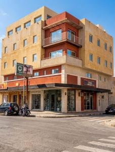 a large building on the corner of a street at Apart Hotel Belgrano in Perico
