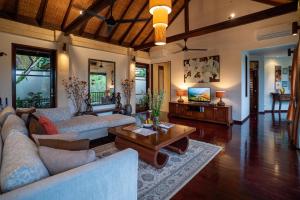 a living room with couches and a coffee table at Villa Ambiente by Nakula in Jimbaran