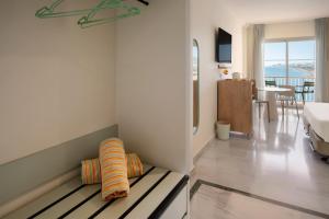 a room with a bench with pillows on it at SOL by Meliá Málaga Guadalmar in Málaga