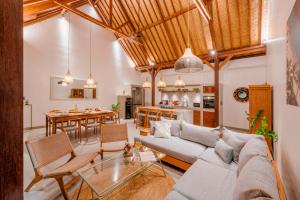 a living room with a couch and a table at Palm Paradise in Nusa Lembongan