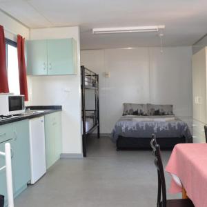 a kitchen and a bedroom with a bed in a room at Collie Tourist Park in Collie