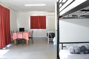 a bedroom with a table and a dining room with a bed at Collie Tourist Park in Collie