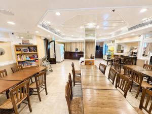 a dining room with wooden tables and chairs at Warwick Hotel Cheung Chau in Hong Kong