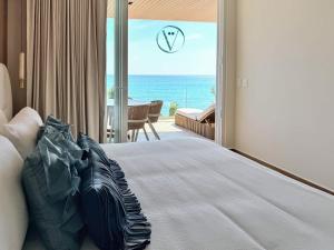 a bedroom with a bed with a view of the ocean at Hear the Waves Luxury Oceanfront Escape in Bucerías