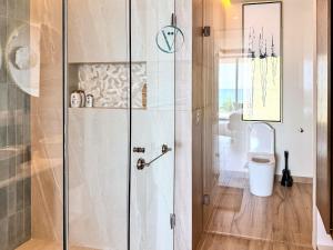 a bathroom with a shower and a toilet at Hear the Waves Luxury Oceanfront Escape in Bucerías
