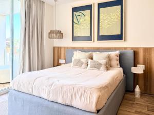 a bedroom with a large bed with white sheets at Hear the Waves Luxury Oceanfront Escape in Bucerías +27 photos