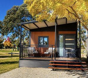 a small house with a screened in porch in a park at Mansfield Holiday Park in Mansfield