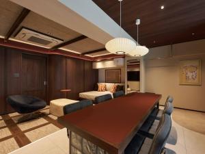 a living room with a table and a bed at illi Atra Aoyama in Tokyo +48 photos
