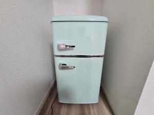 a white refrigerator in a corner of a room at 鶴城丸（KAKUJYOMARU） in Karatsu