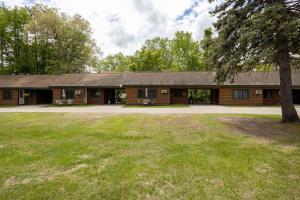 a log cabin with a large yard in front of it at 2BR 1BA Cabin #3 Riverside Point Resort in Park Rapids