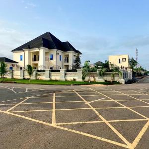 an empty parking lot in front of a house at perficient apartments in Okpanam