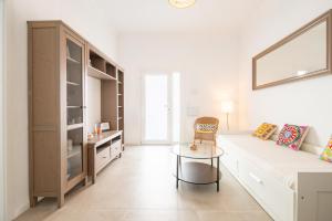 a living room with a white couch and a table at Nafeti in Palma de Mallorca
