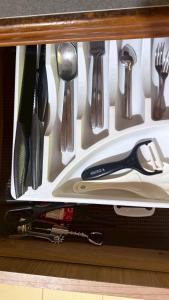 a drawer filled with utensils in a cabinet at Pink Kangaroo Bungalows in Ko Kood