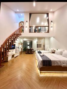 a bedroom with a large bed and a staircase at VILLA MINH HẬU in Cu Lao Thu +46 photos