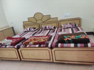 two beds with pillows on them in a bedroom at Silver holidays in Yercaud