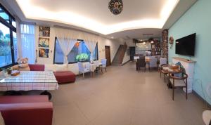 a restaurant with a waiting room with tables and chairs at Bestime B&B in Jiji +28 photos