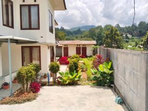 a house with a fence in front of it at Homestay Possere in Sadang