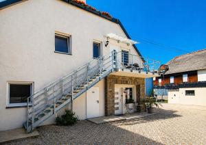 a building with a staircase on the side of it at Ferienwohnung an der Dhron in Neumagen-Dhron