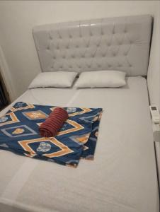 a bed with a white headboard and a red blanket at Surf Homestay Katiet surfing barrrels short motorcycle only minute from our places Bintang wave,Lance wave,HTs wave,monkeyWave in Katiet