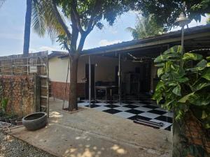 a house with a black and white checkered floor at Nomad Guesthouse by Buntha in Phumĭ Réach Born (2) +13 photos