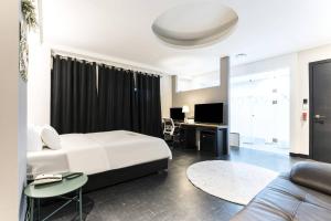 a bedroom with a white bed and a couch at Pandora Hotel in Hwaseong