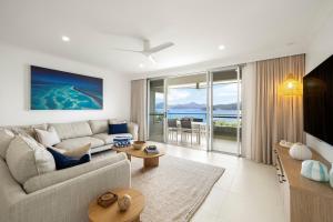 a living room with a couch and a table at Beach Lodges in Hamilton Island