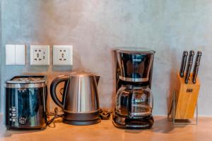 a counter with a coffee maker and a blender on it at Palm Paradise in Nusa Lembongan