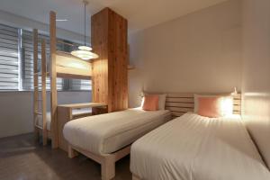 a bedroom with two beds and a bunk bed at Hostel Haru in Seoul