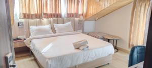 a bedroom with a large bed with a desk and a chair at Katson Blue Dalhousie in Dalhousie +20 photos