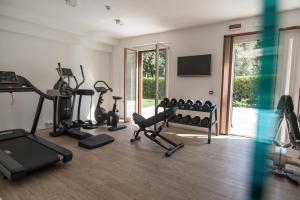a gym with treadmills and exercise bikes in a room at Arli Hotel Hideaway Punta Ala - Adults Only in Punta Ala