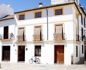 a white house with a bike parked in front of it at Las Casas del Potro in Córdoba