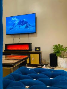 a living room with a flat screen tv on a wall at Private Home in Bugiri