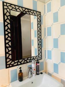 a bathroom with a sink and a mirror on the wall at Private Home in Bugiri