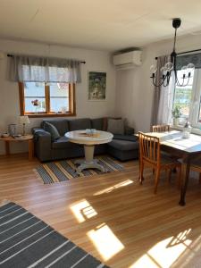 a living room with a couch and a table at Sjönära stuga i flogned in Åmotsfors