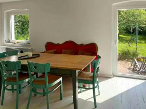 a dining room with a wooden table and chairs at House Between Forest And Fields In Brandenburg in Casekow +32 photos