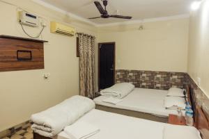 a room with two beds and a window at Aanand Hotel in Janakpur