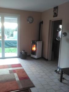 a living room with a fire in a stove at Marielu in Pouilly-sur-Loire