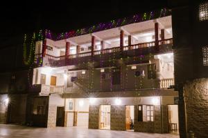 a building with christmas lights on it at night at Aanand Hotel in Janakpur