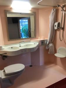 a bathroom with a toilet and a sink and a mirror at Premiere Classe Marseille La Valentine in Marseille +40 photos