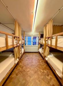 a room with four bunk beds in a room at Ayni Living - Hostel in Lima