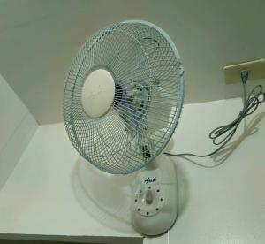 a white fan sitting on top of a table at Duck & Drift - a Sleeper Hostel - Just 1,7km from Airport in Puerto Princesa City
