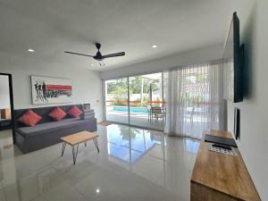 a living room with a couch and a table at SAWAN Residence Pool Villas in Lamai