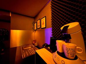 a kitchen with a coffee maker and a coffee cup at Suite XOXO in Souppes-sur-Loing
