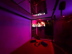 a purple room with a bed and a tv at Suite XOXO in Souppes-sur-Loing +8 photos