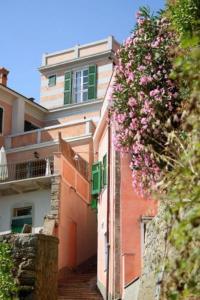a building with flowers hanging off the side of it at Locanda Tramonti in La Spezia