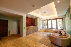 a large living room with a couch and a table at Hotel Ryon Mamaia-Nord in Mamaia Sat/Năvodari