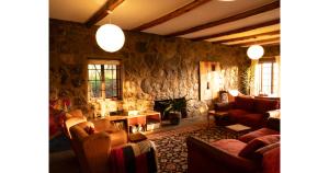 a living room with couches and a stone wall at Oloile - Home By The Park in Nairobi
